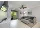 Inviting living room with a sliding glass door to the balcony, ceiling fan and tile floors at 5691 Bentgrass Dr # 211, Sarasota, FL 34235