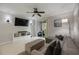 Inviting living room with a sliding glass door to the balcony, ceiling fan and tile floors at 5691 Bentgrass Dr # 211, Sarasota, FL 34235
