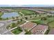 Scenic aerial view of homes on a golf course, featuring a lush green landscape and a tranquil lake at 5811 Brandon Run, Bradenton, FL 34211