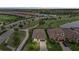 Aerial view of a well-maintained neighborhood with lush landscaping, golf course, and a lake in a beautiful community at 5811 Brandon Run, Bradenton, FL 34211