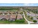 Aerial view of homes in a golf community featuring manicured lawns, tile roofs, and neighborhood landscaping at 5811 Brandon Run, Bradenton, FL 34211