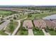Aerial view of two homes with tiled roofs, landscaped yards, and a winding pathway in a serene community setting at 5811 Brandon Run, Bradenton, FL 34211