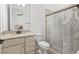 Classic bathroom showcasing a granite vanity, modern fixtures, and a shower with a neutral shower curtain at 5811 Brandon Run, Bradenton, FL 34211