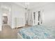 Light-filled bedroom with tiled floors, white dresser, and a view to the hallway at 5811 Brandon Run, Bradenton, FL 34211