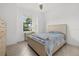 Cozy bedroom with neutral tones, tiled floors, and a large window with outdoor view at 5811 Brandon Run, Bradenton, FL 34211