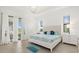 Bright bedroom with a tray ceiling, tile floors, and access to outdoor patio at 5811 Brandon Run, Bradenton, FL 34211