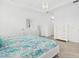 Bright bedroom boasts a tray ceiling, neutral decor, and tiled floors at 5811 Brandon Run, Bradenton, FL 34211