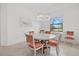 Bright dining room features elegant chandelier, round table with seating, and a large window for lots of natural light at 5811 Brandon Run, Bradenton, FL 34211
