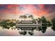 Community entrance with decorative signage, lush landscaping, and reflective water features for a serene welcome at 5811 Brandon Run, Bradenton, FL 34211