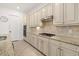 Bright kitchen boasts stainless appliances, custom cabinets, granite counters, decorative backsplash, and tiled floors at 5811 Brandon Run, Bradenton, FL 34211