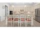 Bright kitchen boasts granite counters, stainless appliances, a center island with bar seating, and stylish pendant lighting at 5811 Brandon Run, Bradenton, FL 34211