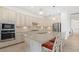 Well-equipped kitchen with granite countertops, stainless steel appliances, and a breakfast bar with seating at 5811 Brandon Run, Bradenton, FL 34211