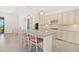 Spacious kitchen boasts stainless appliances, custom cabinets, granite counters, a center island, and stylish pendant lighting at 5811 Brandon Run, Bradenton, FL 34211