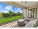 The beautiful lanai features comfortable seating and views of the landscaped backyard at 5811 Brandon Run, Bradenton, FL 34211