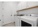 Well-organized laundry room with modern washer and dryer, ample storage, and a functional design at 5811 Brandon Run, Bradenton, FL 34211
