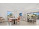 Bright living room featuring modern lighting, dining table, comfortable seating and a sliding glass door at 5811 Brandon Run, Bradenton, FL 34211