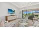 Bright living room featuring comfortable seating, sliding glass door, and modern chandelier at 5811 Brandon Run, Bradenton, FL 34211