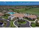Aerial view of the community featuring a pool, clubhouse, golf course, and luxurious homes at 5917 Cessna Run, Lakewood Ranch, FL 34211