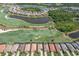 High-angle aerial image displays residential homes surrounding a vast golf course, lakes, and natural landscapes, offering luxurious living at 5917 Cessna Run, Lakewood Ranch, FL 34211
