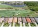 Expansive aerial view showcasing homes with manicured lawns next to a beautiful golf course and lake, in a desirable community at 5917 Cessna Run, Lakewood Ranch, FL 34211