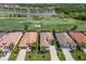 Stunning aerial view of homes adjacent to a lush golf course and tranquil lake, showcasing the community's premium location at 5917 Cessna Run, Lakewood Ranch, FL 34211