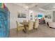 Dining room with a wooden table, six upholstered chairs, a unique cabinet, and decorative lighting at 5917 Cessna Run, Lakewood Ranch, FL 34211