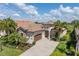 Stunning single Gathering home boasting lush landscaping, paver driveway, and charming stone accents at 5917 Cessna Run, Lakewood Ranch, FL 34211