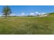 Expansive, well-manicured golf course features lush green grass and mature trees under a bright sky at 5917 Cessna Run, Lakewood Ranch, FL 34211