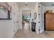 Bright hallway with tile flooring, white trim, and a glimpse of the living area and view at 5917 Cessna Run, Lakewood Ranch, FL 34211