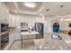 Bright kitchen boasts stainless steel appliances, an island, and ample cabinet space at 5917 Cessna Run, Lakewood Ranch, FL 34211