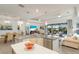 Open-concept kitchen with an island, pendant lighting, and seamless flow to the living area and pool at 5917 Cessna Run, Lakewood Ranch, FL 34211