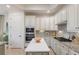 Well-lit kitchen features stainless steel appliances, granite countertops, and a center island at 5917 Cessna Run, Lakewood Ranch, FL 34211