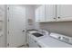 Well-equipped laundry room featuring modern washer and dryer units at 5917 Cessna Run, Lakewood Ranch, FL 34211