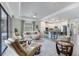 Open-concept living area with a kitchen and a view of the screened-in patio and outdoor living space at 5917 Cessna Run, Lakewood Ranch, FL 34211