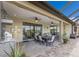 The outdoor kitchen features a granite countertop, stainless steel grill, brick flooring, and covered dining at 5917 Cessna Run, Lakewood Ranch, FL 34211