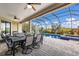 Screened patio with outdoor dining set and views of the pool and golf course at 5917 Cessna Run, Lakewood Ranch, FL 34211