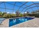 The screened-in pool features a spa and lush landscaping at 5917 Cessna Run, Lakewood Ranch, FL 34211
