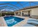 The screened-in pool features a spa, outdoor kitchen, and seating areas for entertaining at 5917 Cessna Run, Lakewood Ranch, FL 34211