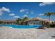 Resort-style pool with a waterfall, palm trees, and lounge chairs, perfect for relaxation and recreation at 5917 Cessna Run, Lakewood Ranch, FL 34211