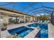 The screened-in pool features a spa and outdoor entertaining spaces at 5917 Cessna Run, Lakewood Ranch, FL 34211