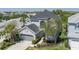 Aerial view of a charming two-story home with a well-maintained lawn and an attached two-car garage at 6210 Laurel Creek Trl, Ellenton, FL 34222