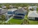 Aerial view of a gray home with a green yard and a screened patio at 6210 Laurel Creek Trl, Ellenton, FL 34222