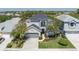 Aerial view of a charming two-story home with a well-maintained lawn and an attached two-car garage at 6210 Laurel Creek Trl, Ellenton, FL 34222