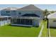 Large backyard with a screened lanai and a white fence at 6210 Laurel Creek Trl, Ellenton, FL 34222