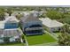 Aerial view of the back of a gray home with a lanai and a green yard at 6210 Laurel Creek Trl, Ellenton, FL 34222
