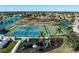 An aerial view of the community's tennis courts, basketball court, playground, and scenic lake at 6210 Laurel Creek Trl, Ellenton, FL 34222