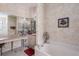 Bright bathroom featuring a tub, vanity, decorative wallpaper, and tiled floor at 6210 Laurel Creek Trl, Ellenton, FL 34222