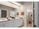 Bathroom featuring double sinks, vanity, and tiled flooring near a glass shower at 6210 Laurel Creek Trl, Ellenton, FL 34222