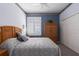 Cozy bedroom featuring a window with shutters and a large wardrobe closet at 6210 Laurel Creek Trl, Ellenton, FL 34222