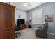 Home office with built-in desk, comfy chair, and a window with white shutters at 6210 Laurel Creek Trl, Ellenton, FL 34222
